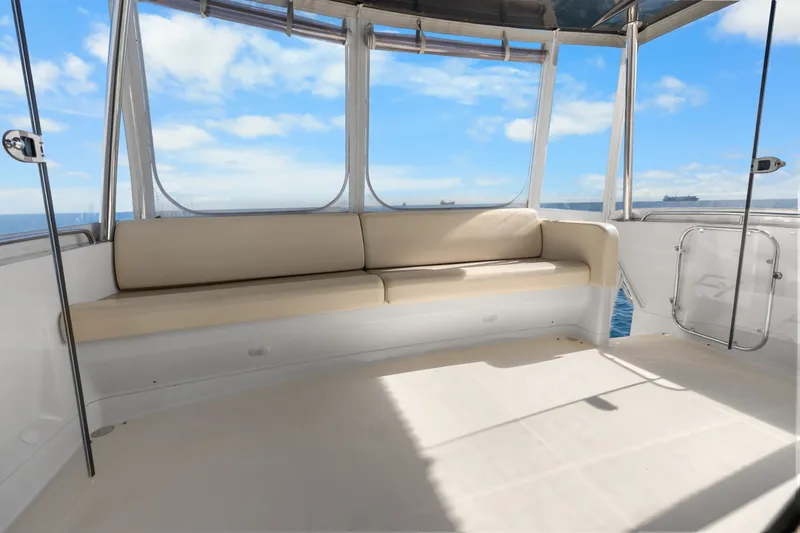 Slide: The Image of 2012 Carver 41 Cockpit Motor Yacht interior with beige seating and ocean view. - 21