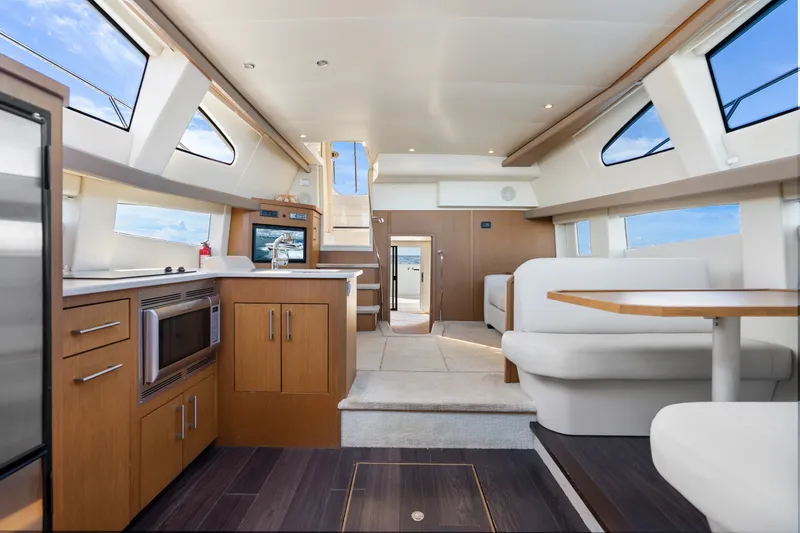 Slide: The Image of Luxurious interior of 2012 Carver 41 Cockpit Motor Yacht with modern kitchen and seating area. - 26