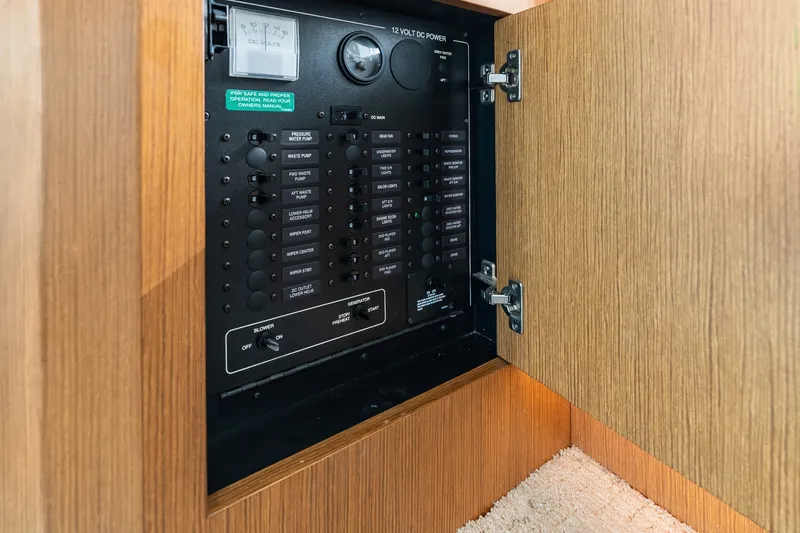 Slide: The Image of Electrical panel inside 2012 Carver 41 Cockpit Motor Yacht, featuring various switches and controls. - 46