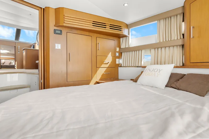 Slide: The Image of Luxurious interior of 2012 Carver 41 Cockpit Motor Yacht with cozy bedroom and elegant wood finishes. - 36
