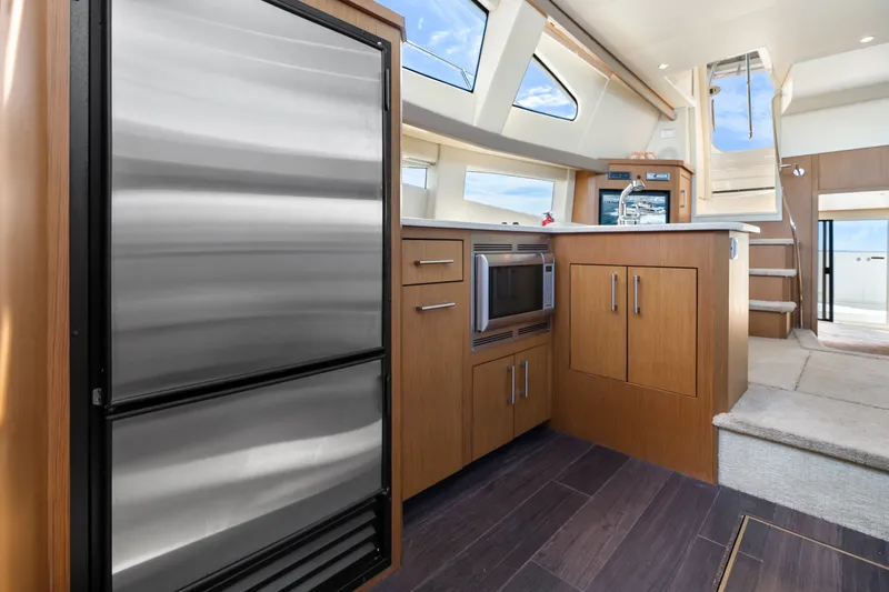 Slide: The Image of Interior of 2012 Carver 41 Cockpit Motor Yacht with modern kitchen amenities. - 27