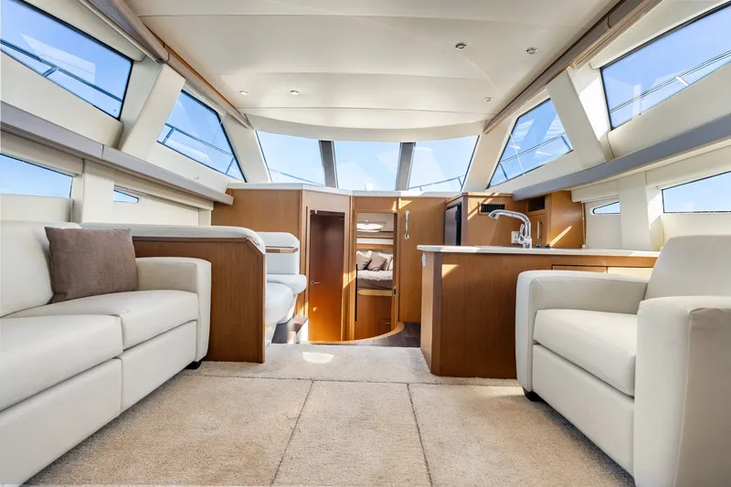 Slide: The Image of Luxurious interior of 2012 Carver 41 Cockpit Motor Yacht with modern furnishings and panoramic windows. - 22