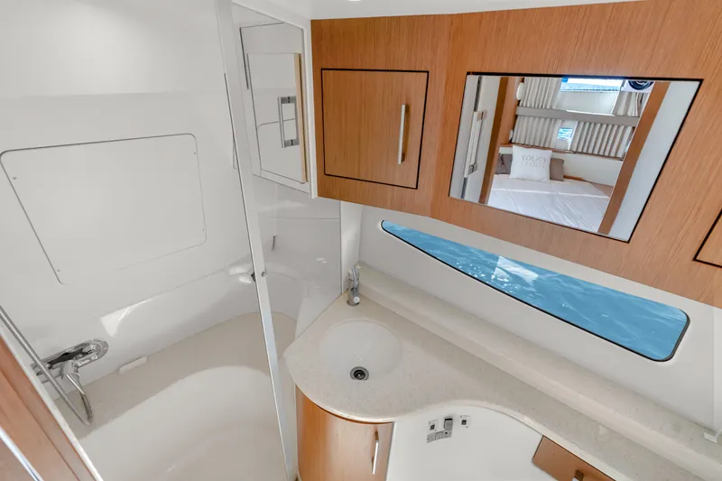 Slide: The Image of Luxurious bathroom in 2012 Carver 41 Cockpit Motor Yacht with modern fixtures and wood accents. - 37