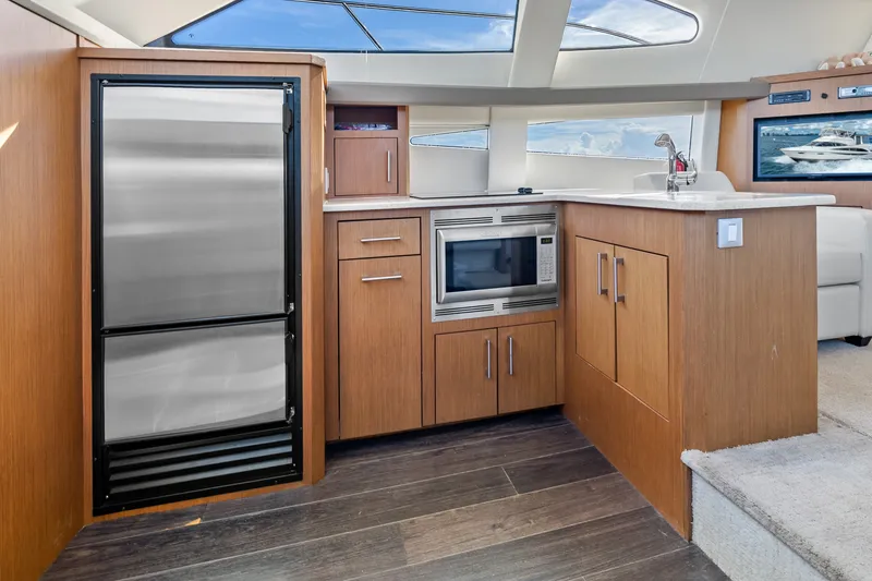 Slide: The Image of Modern kitchen interior of 2012 Carver 41 Cockpit Motor Yacht with stainless steel appliances. - 28
