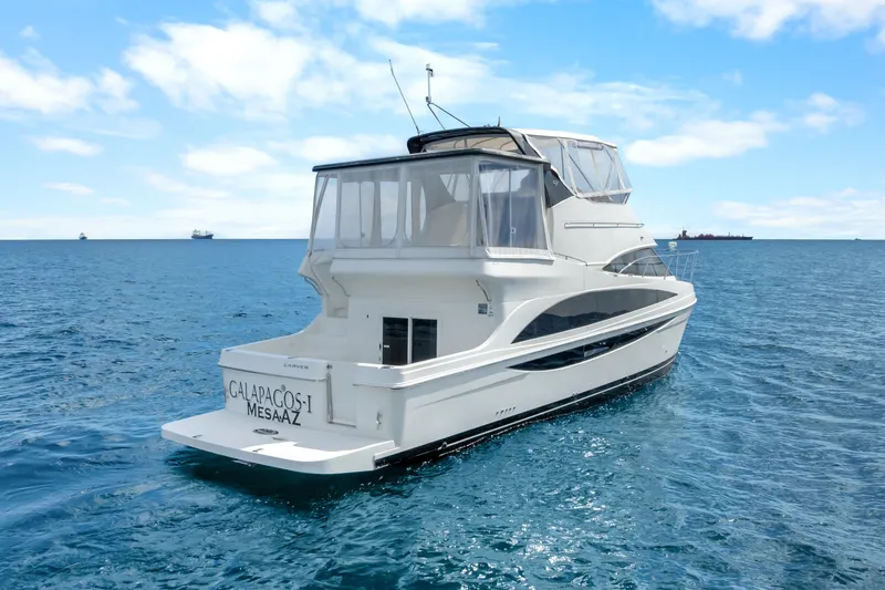 Slide: The Image of 2012 Carver 41 Cockpit Motor Yacht on open sea under clear skies. - 11