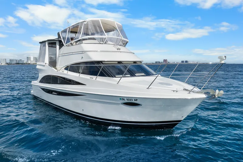 Slide: The Image of 2012 Carver 41 Cockpit Motor Yacht cruising on open water under a clear sky. - 1