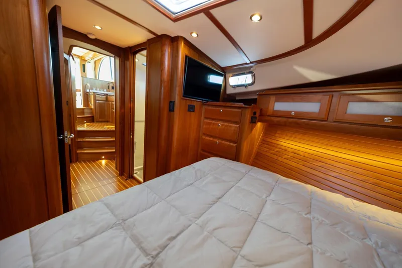 Slide: The Image of Luxurious interior of 2021 Sabre 45 Salon Express yacht with wood finish and cozy bedding. - 31