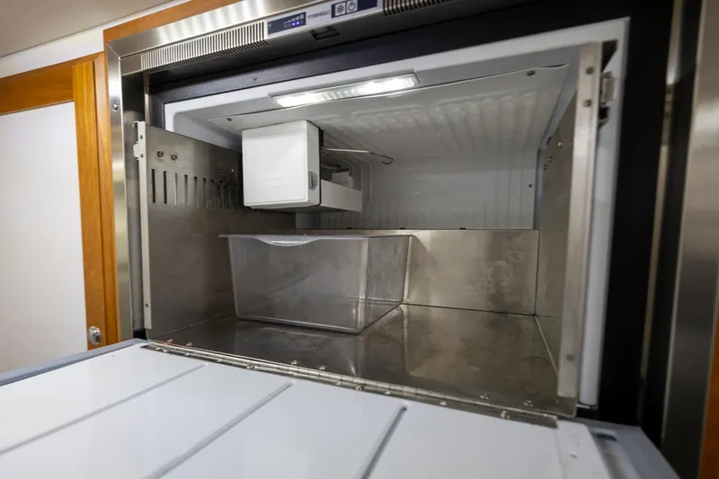 Slide: The Image of Interior view of a 2021 Sabre 45 Salon Express refrigerator compartment. - 38