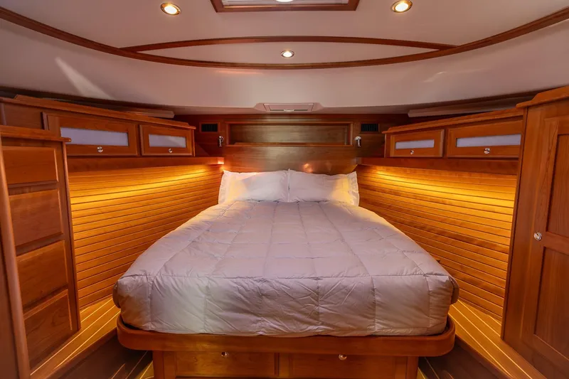 Slide: The Image of Luxurious cabin interior of 2021 Sabre 45 Salon Express yacht with cozy bed and warm lighting. - 30