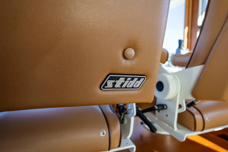 Slide: The Image of Brown leather seat with "Stidd" logo on a 2021 Sabre 45 Salon Express yacht. - 16