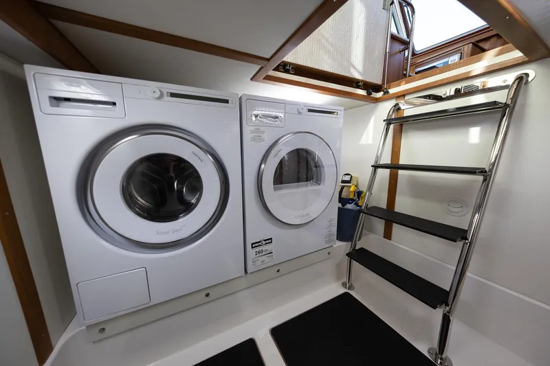 Slide: The Image of Laundry area with washer and dryer in 2021 Sabre 45 Salon Express yacht. - 36