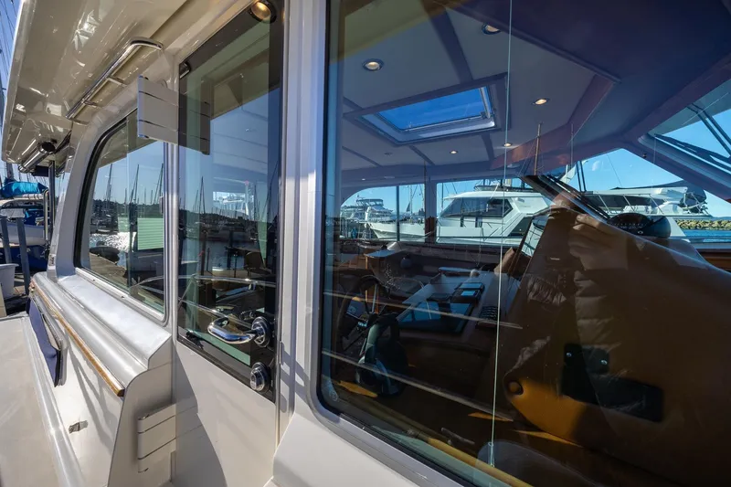 Slide: The Image of 2021 Sabre 45 Salon Express yacht with sleek glass windows and luxurious interior. - 3