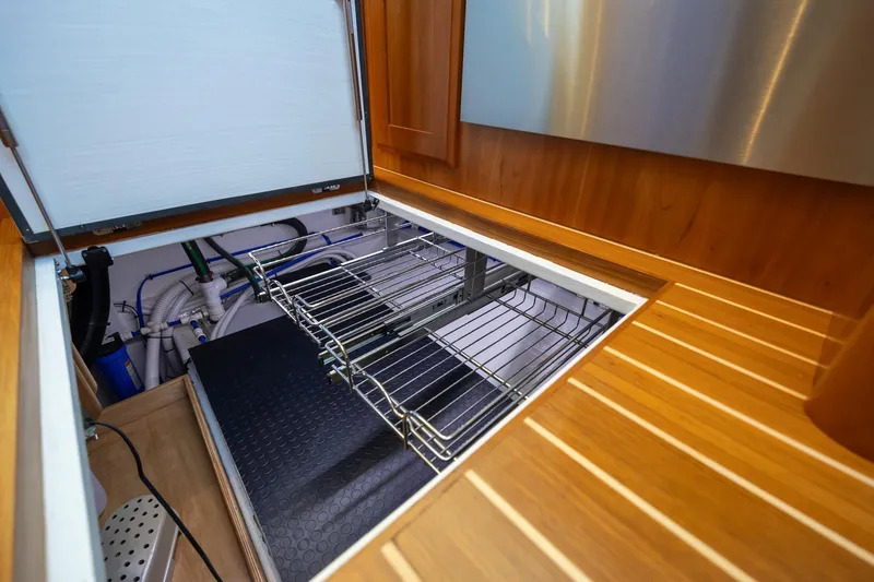 Slide: The Image of 2021 Sabre 45 Salon Express engine compartment with open hatch and visible wiring. - 25