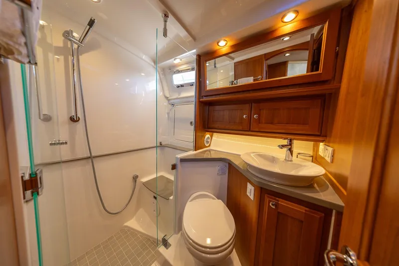 Slide: The Image of Luxurious bathroom in 2021 Sabre 45 Salon Express yacht with modern fixtures and wooden cabinetry. - 29