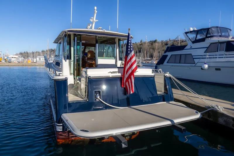 Slide: The Image of 2021 Sabre 45 Salon Express yacht docked with American flag displayed. - 5