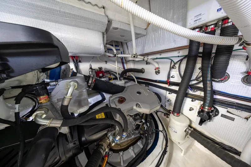 Slide: The Image of Engine room of 2021 Sabre 45 Salon Express yacht, showcasing complex machinery and piping. - 41