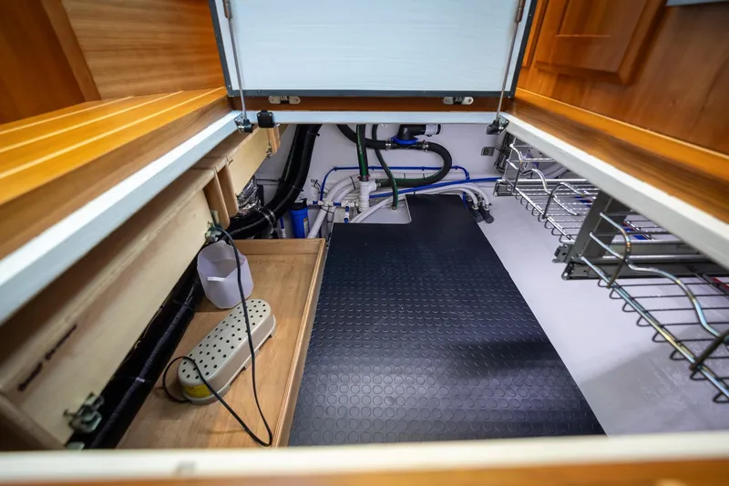 Slide: The Image of Engine room of 2021 Sabre 45 Salon Express yacht, featuring organized wiring and storage. - 24