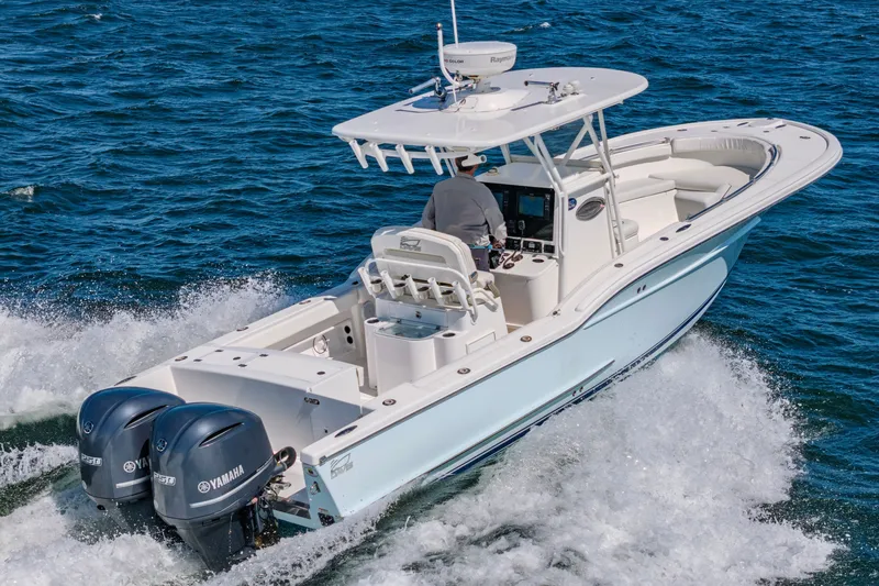 Slide: The Image of 2016 Buddy Davis 28 Center Console boat cruising on open water. - 2
