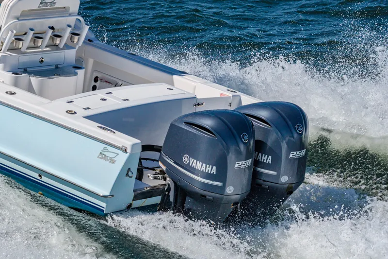 Slide: The Image of 2016 Buddy Davis 28 Center Console boat with twin Yamaha 250 engines on water. - 4