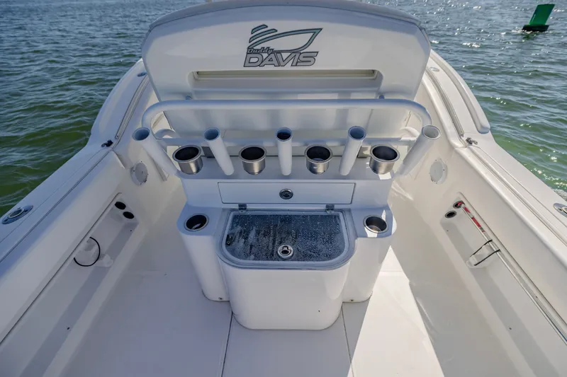 Slide: The Image of 2016 Buddy Davis 28 Center Console boat interior with rod holders and storage. - 9
