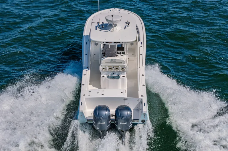 Slide: The Image of 2016 Buddy Davis 28 Center Console boat cruising on open water. - 5