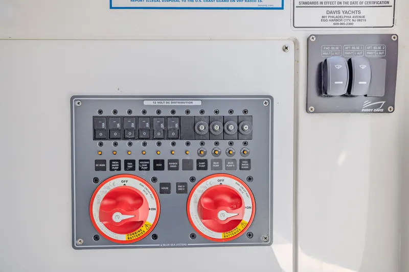 Slide: The Image of Control panel of a 2016 Buddy Davis 28 Center Console boat, featuring switches and battery dials. - 16