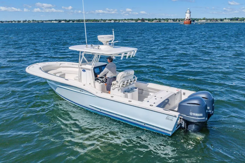 Slide: The Image of 2016 Buddy Davis 28 Center Console boat on open water with dual Yamaha engines. - 3