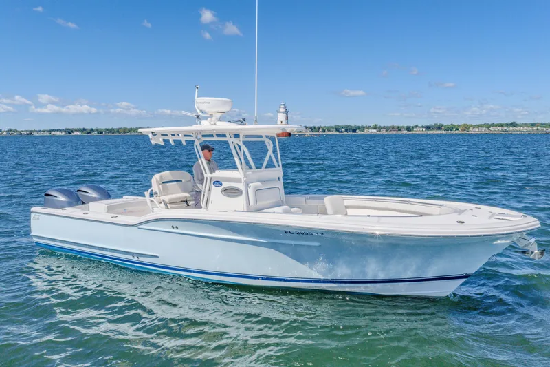 Slide: The Image of 2016 Buddy Davis 28 Center Console boat cruising on open water under clear skies. - 18
