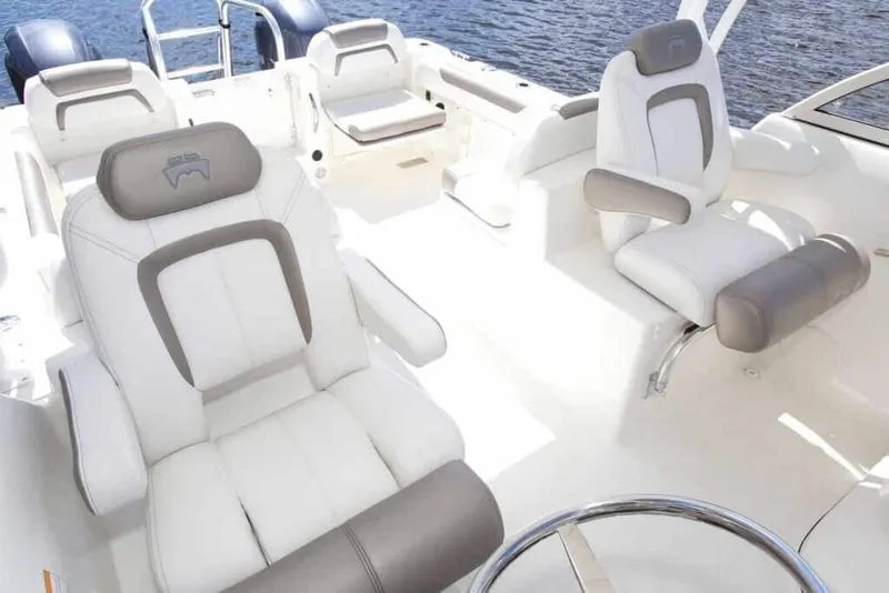 Slide: The Image of The image shows the cockpit of a World Cat 255 DC boat with luxurious white seating. - 9