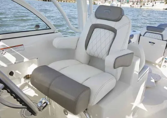 Slide: The Image of A luxurious captain's chair on a boat with gray and white upholstery, surrounded by water. - 20