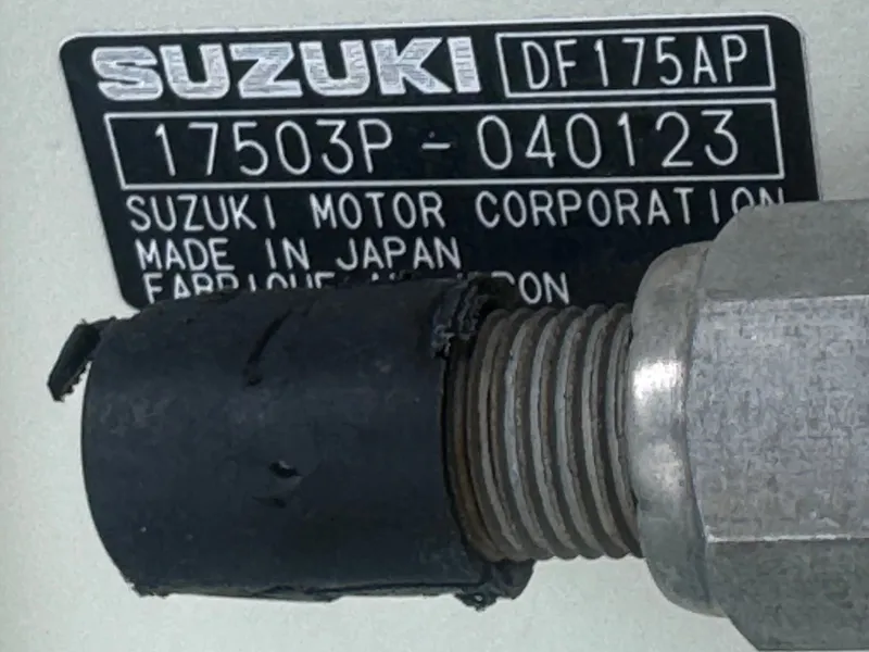 Slide: The Image of Close-up of a Suzuki engine part with serial number and manufacturing details. - 25