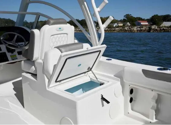 Slide: The Image of A 2013 World Cat 255 DC with an open storage compartment on deck, surrounded by water. - 19