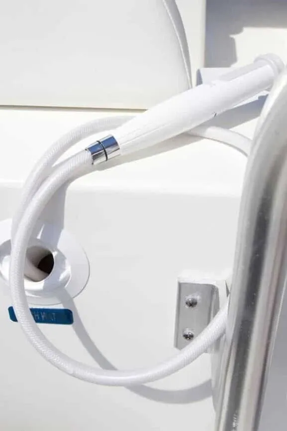 Slide: The Image of Close-up of a white hose on a boat, attached to a metal bracket. - 22