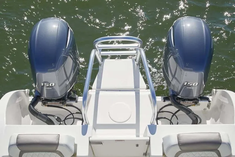 Slide: The Image of Two outboard motors on a boat over calm water, with a sturdy rear railing. - 6