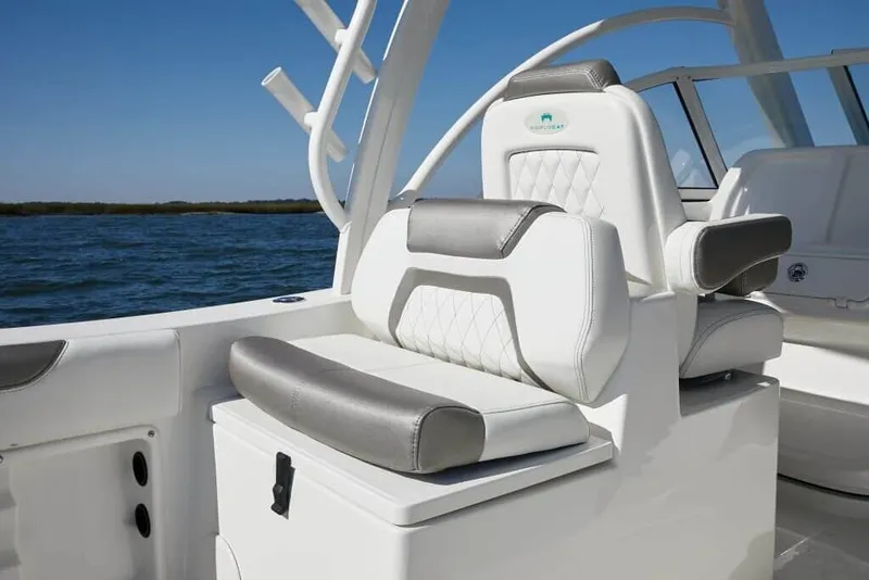 Slide: The Image of The image shows the interior of a 2013 World Cat 255 DC boat with sleek white and gray seating. - 14