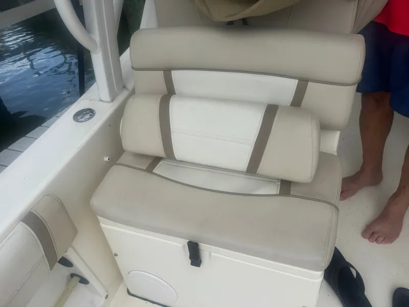 Slide: The Image of A beige seat cushion on a boat with white and brown accents. - 13