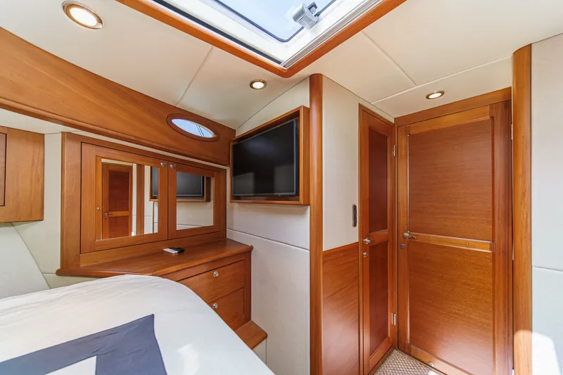 Slide: The Image of Luxurious 2019 Palm Beach Motor Yachts Express cabin interior with wood finishes and modern amenities. - 22