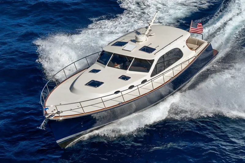 Slide: The Image of 2019 Palm Beach Motor Yachts Express cruising on open water, showcasing sleek design and performance. - 45