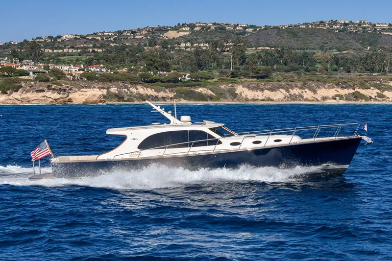 Slide: The Image of 2019 Palm Beach Motor Yachts Express cruising near scenic coastline. - 32