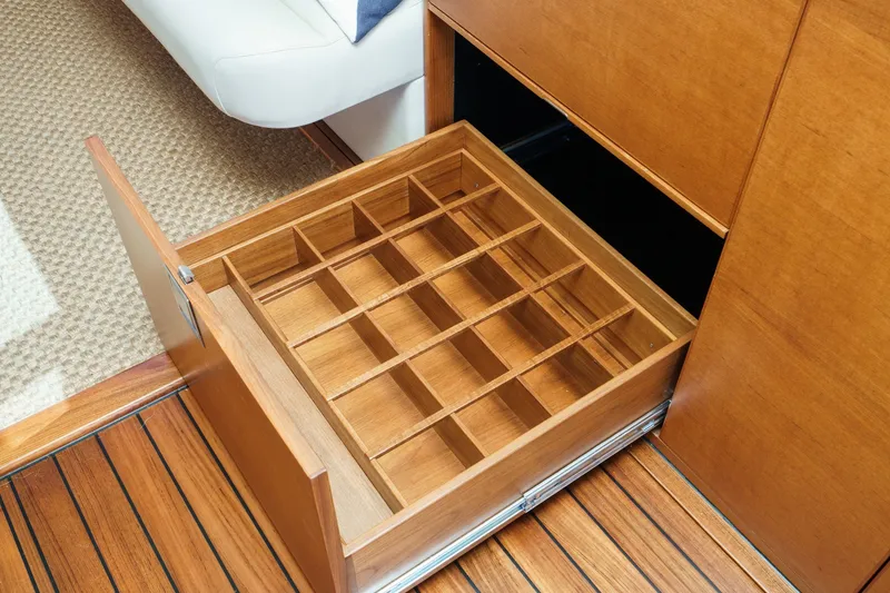 Slide: The Image of 2019 Palm Beach Motor Yachts Express interior with open wooden storage drawer. - 18