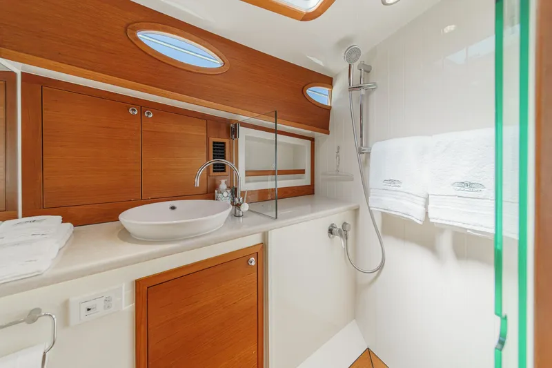 Slide: The Image of Luxurious 2019 Palm Beach Motor Yachts Express bathroom with elegant wood accents and modern fixtures. - 23