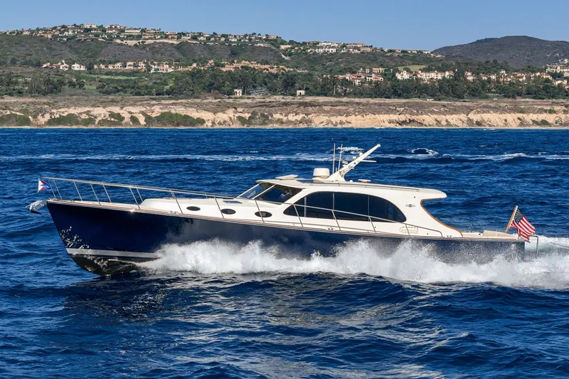 Slide: The Image of 2019 Palm Beach Motor Yachts Express cruising on blue ocean near scenic coastline. - 41