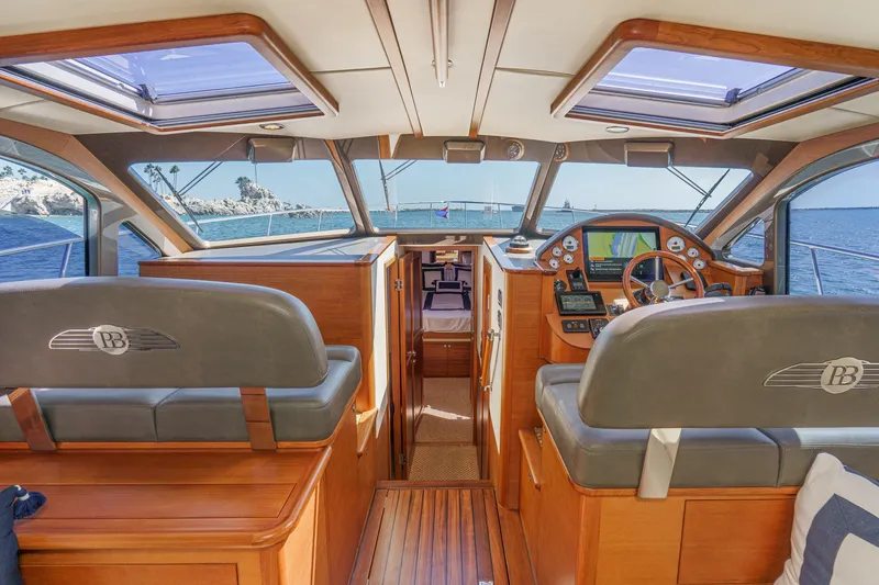 Slide: The Image of 2019 Palm Beach Motor Yachts Express interior with wooden finish and ocean view. - 19