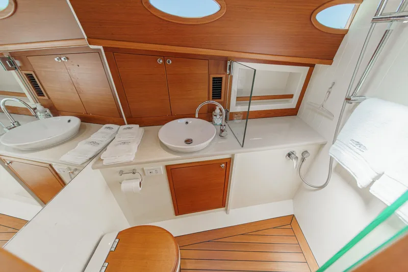 Slide: The Image of Luxurious bathroom interior of 2019 Palm Beach Motor Yachts Express, featuring wood accents and modern fixtures. - 24