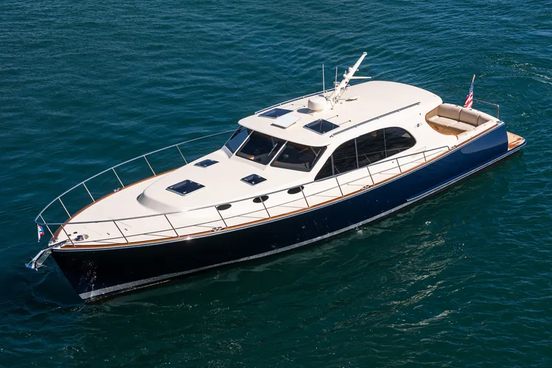 Slide: The Image of 2019 Palm Beach Motor Yachts Express cruising on open water, showcasing sleek design and luxury. - 43