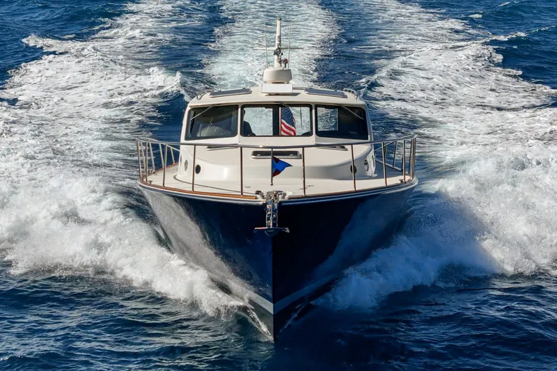 Slide: The Image of 2019 Palm Beach Motor Yachts Express cruising on open water, creating a dynamic wake. - 48