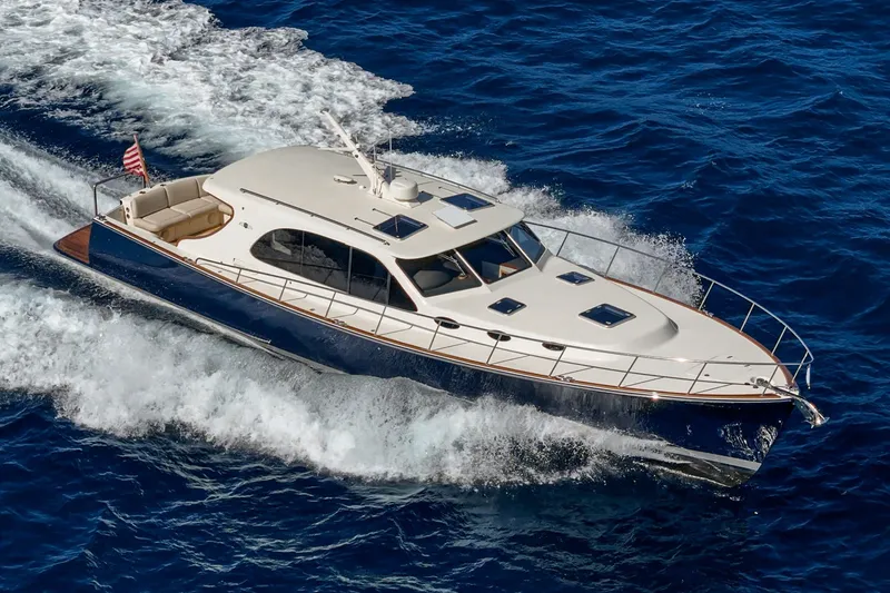Slide: The Image of 2019 Palm Beach Motor Yachts Express cruising on open blue ocean waters. - 51