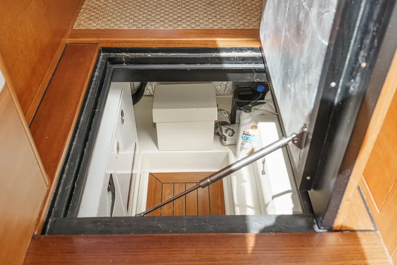 Slide: The Image of Engine compartment of 2019 Palm Beach Motor Yachts Express, showcasing storage and maintenance area. - 29