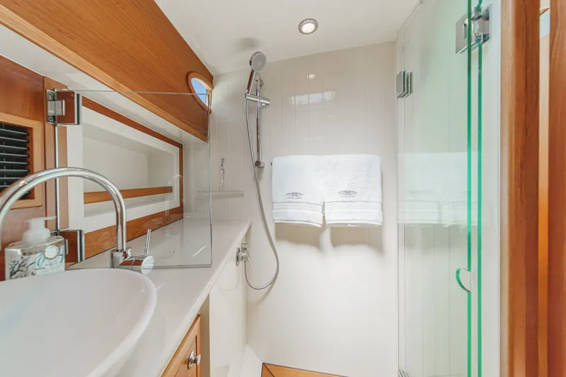 Slide: The Image of Luxurious bathroom in 2019 Palm Beach Motor Yachts Express, featuring modern fixtures and elegant wood accents. - 25