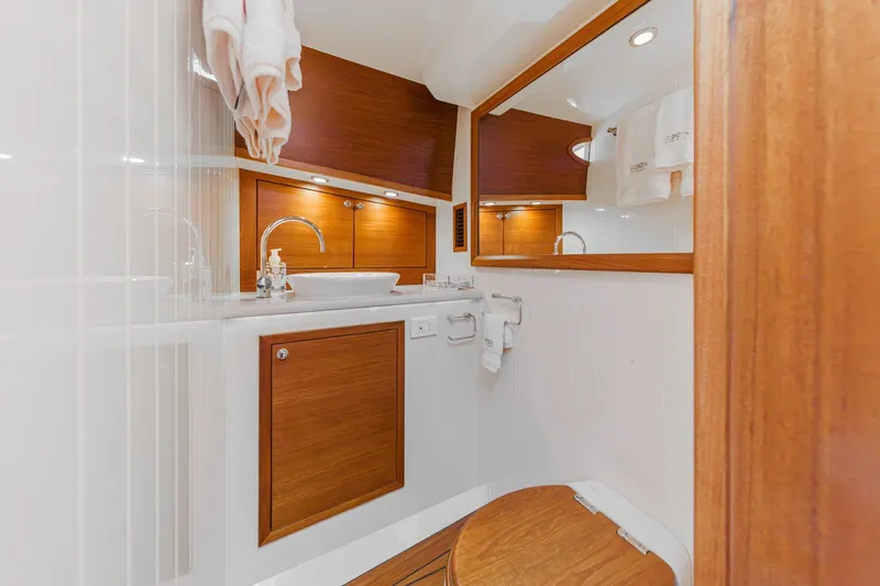 Slide: The Image of Luxurious 2019 Palm Beach Motor Yachts Express bathroom with wood accents and modern fixtures. - 28